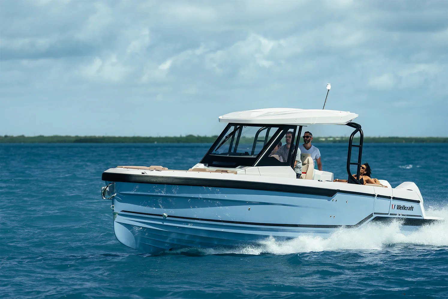 Wellcraft cabin cruiser with a hardtop running on blue water off the Florida coast